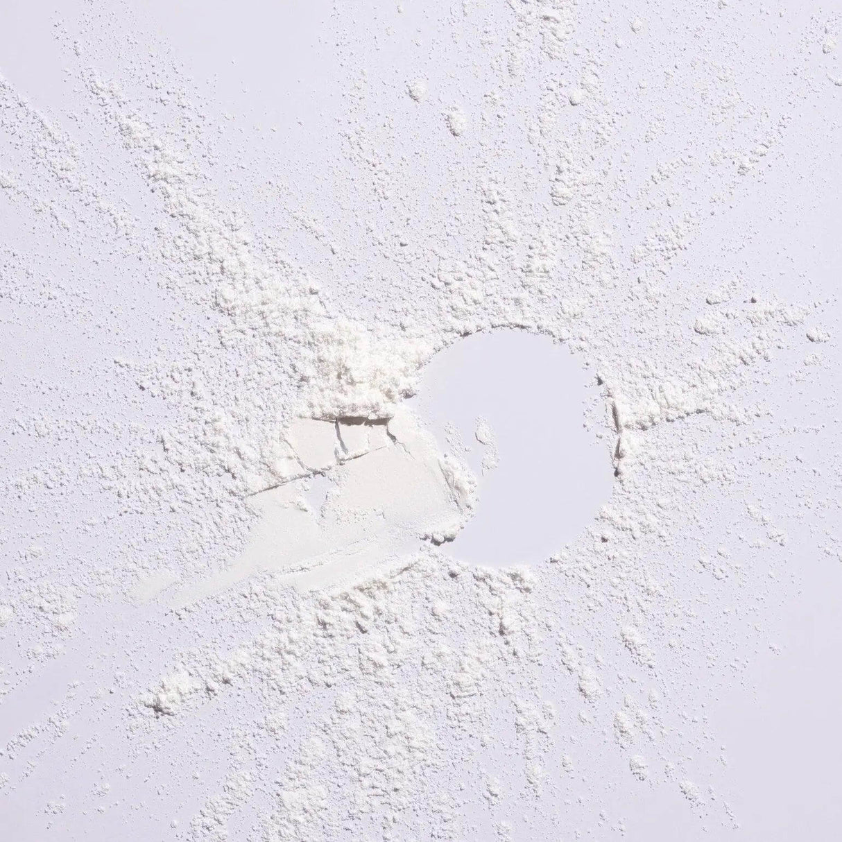 Serene Scalp Oil Control Dry Shampoo Powder spread on a white surface, showcasing its fine texture suitable for oily scalps.