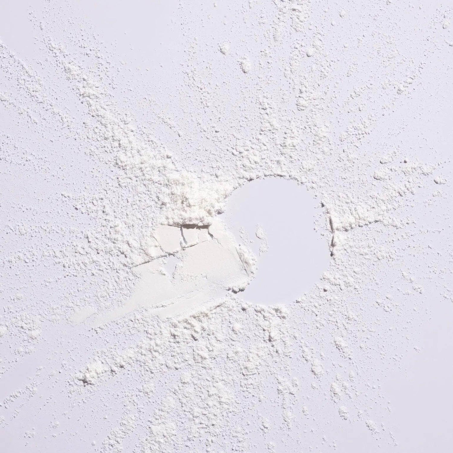 Serene Scalp Oil Control Dry Shampoo Powder spread on a white surface, showcasing its fine texture suitable for oily scalps.