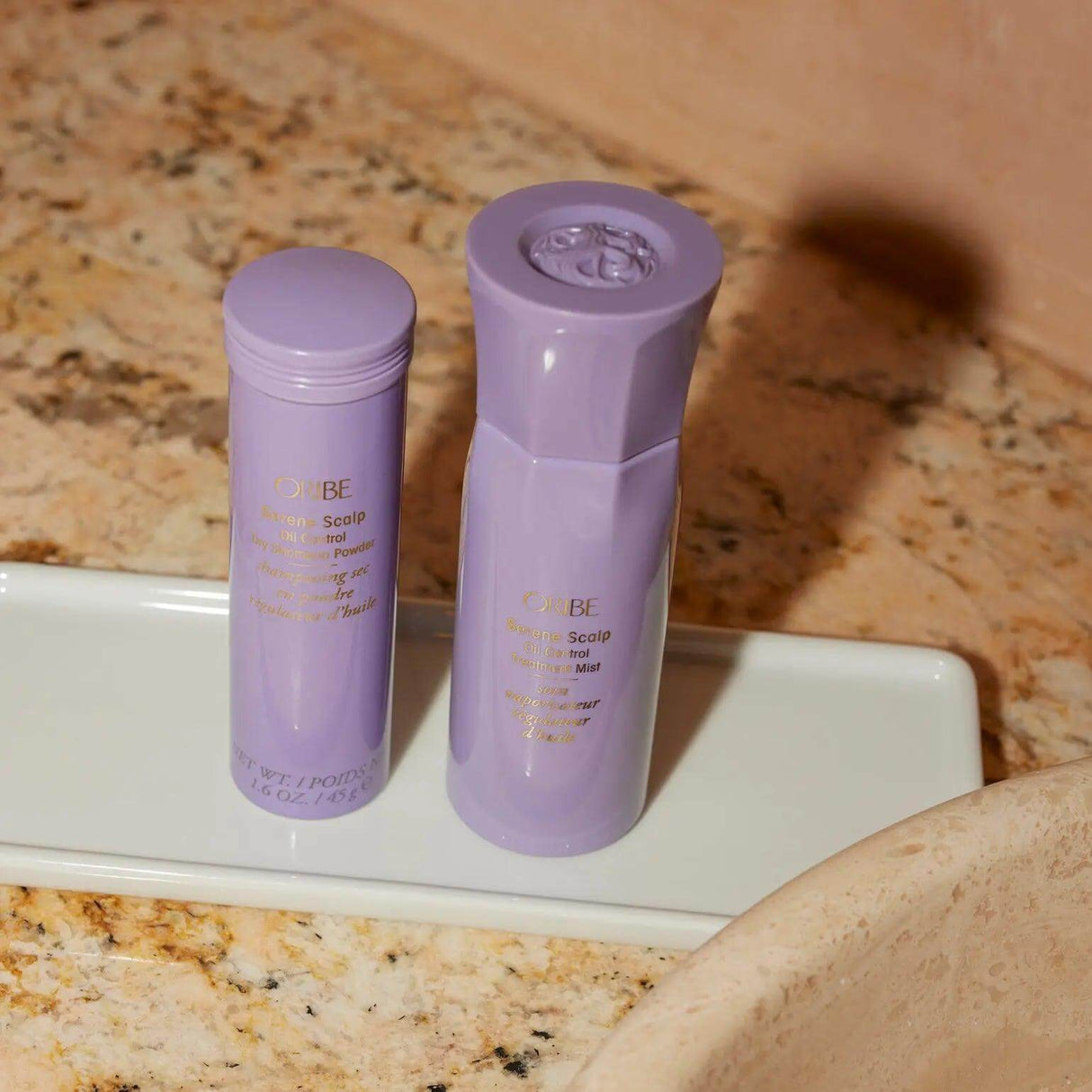 Serene Scalp Oil Control Dry Shampoo Powder bottles by Shu Uemura on a bathroom counter.
