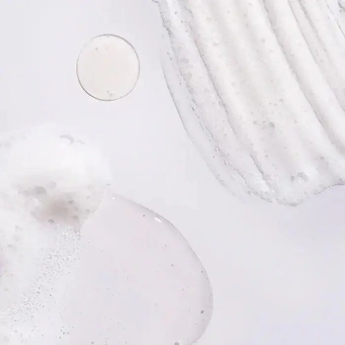Texture of Oribe Serene Scalp Oil Control Shampoo, showing its foamy and silky consistency.