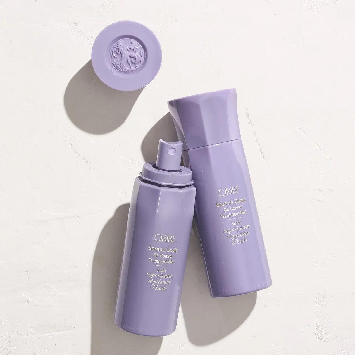 Oribe Serene Scalp Oil Control Treatment Mist bottles on a light background for oily hair and scalp care.