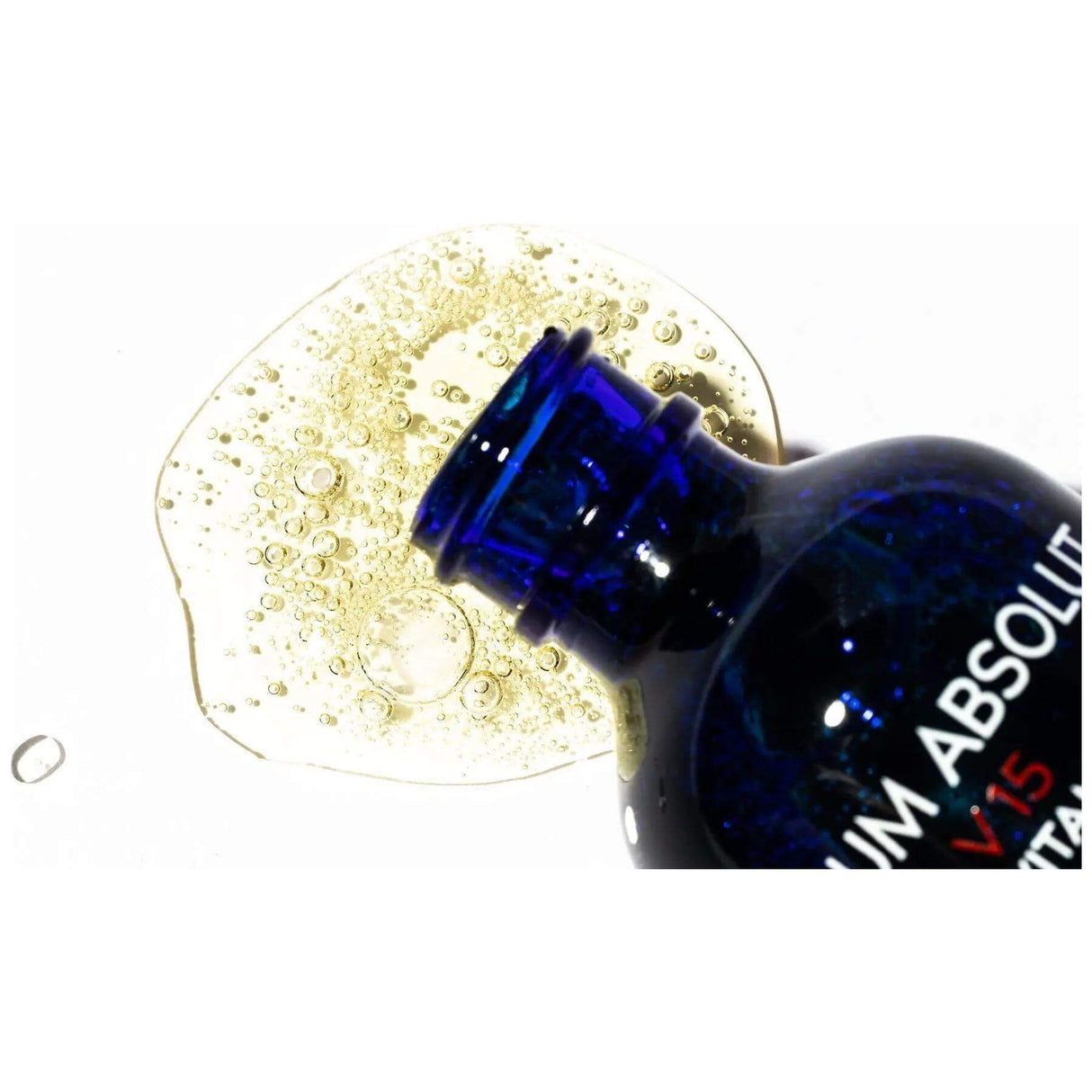 Serum Absolut V15 bottle with serum, targeting fine lines, wrinkles, and pigmentation for all skin types.