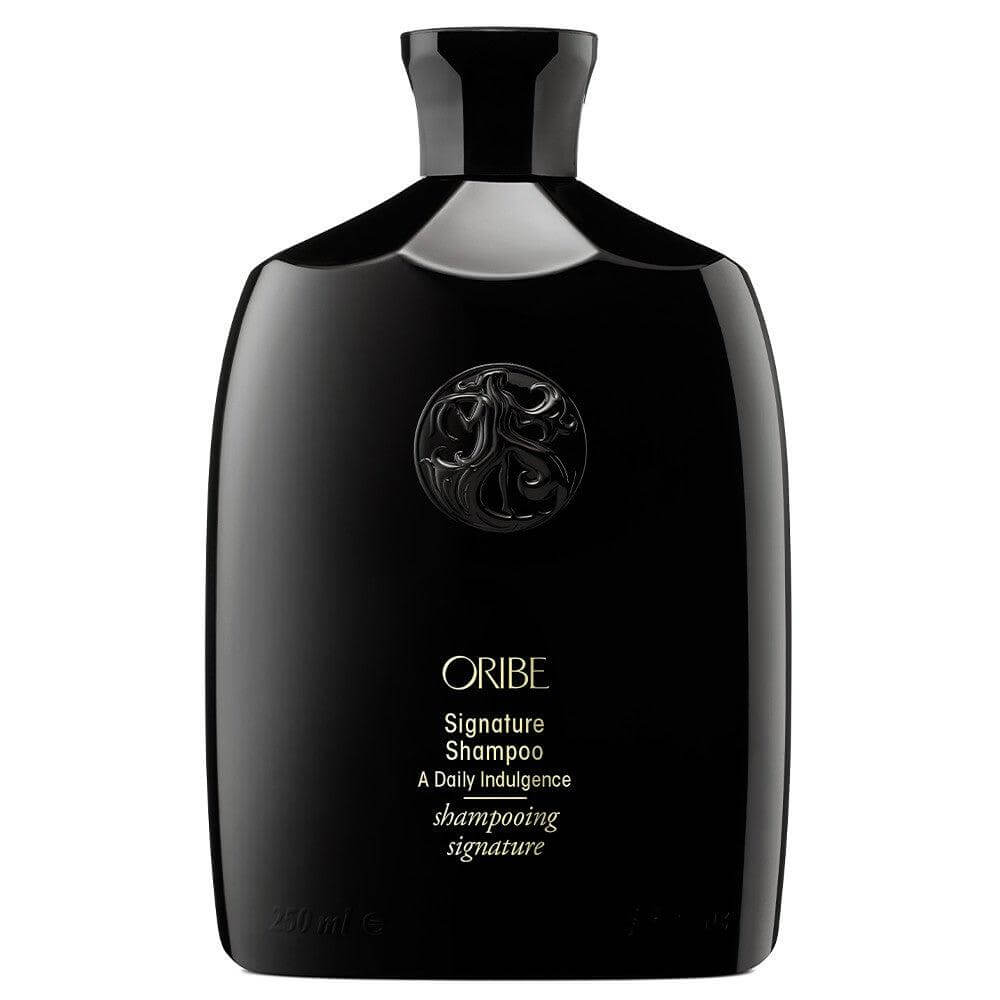 Oribe Signature Shampoo in sleek black bottle for men's hair care.