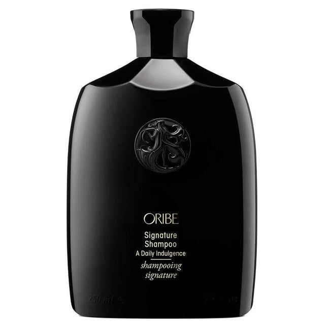 Oribe Signature Shampoo in sleek black bottle for men's hair care.