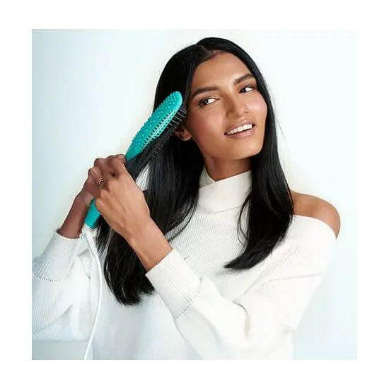 Woman using Smooth Style Ceramic Heated Brush for sleek hair styling