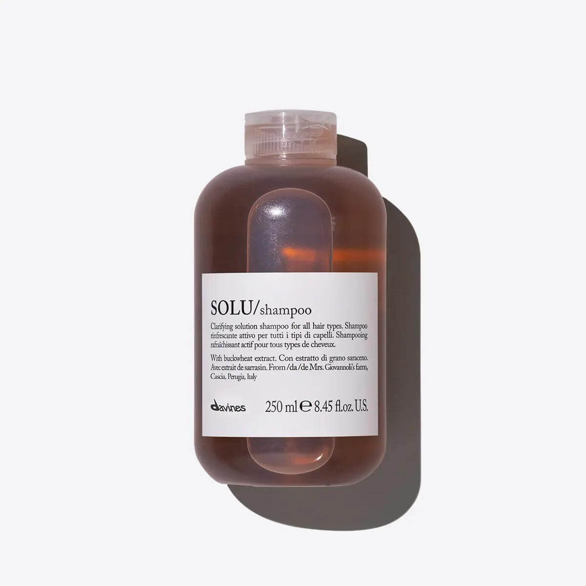 Solu Shampoo bottle for deep cleansing of all hair types, featuring a luxurious light foam to eliminate styling residue.