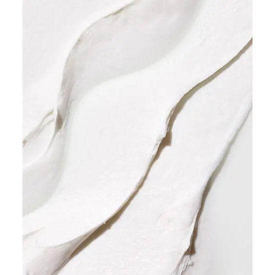 Close-up of creamy texture of fiber-rich molding cream for hair styling, enriched with argan and olive oils for hydration and elasticity.