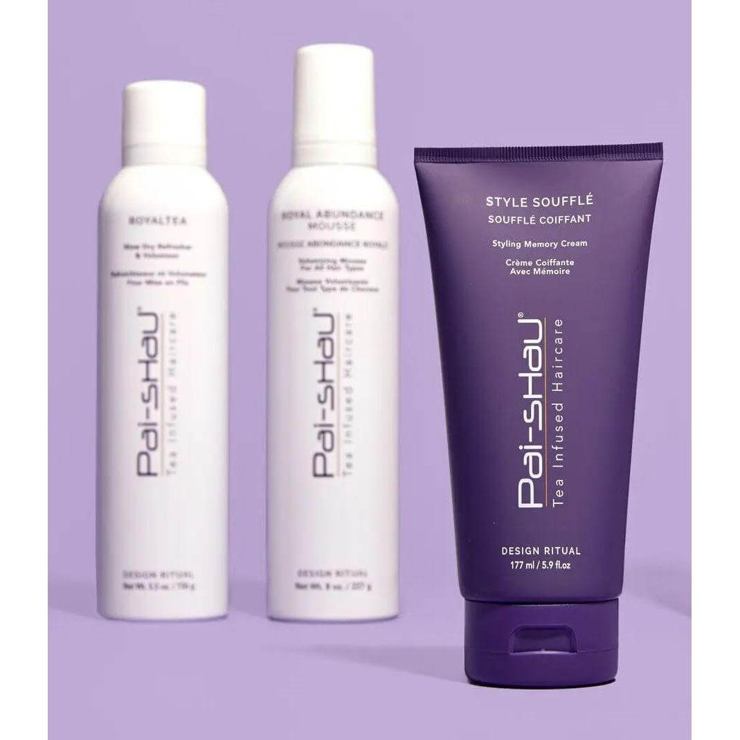 Pai-Shau Style Soufflé styling memory cream with Royal Abundance and Royal Tea hair products in purple bottles on display.