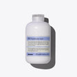 Davines SU Hair & Body Wash bottle on a gray background, hydrating shampoo with antioxidant properties for sun-exposed hair and skin.