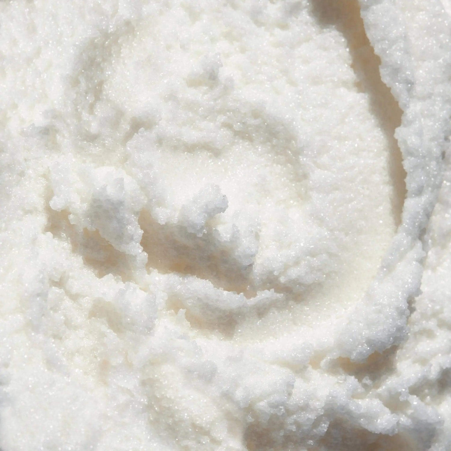 Close-up of textured sugar coconut sugar scrub, highlighting its luxurious exfoliating and hydrating properties for radiant skin.