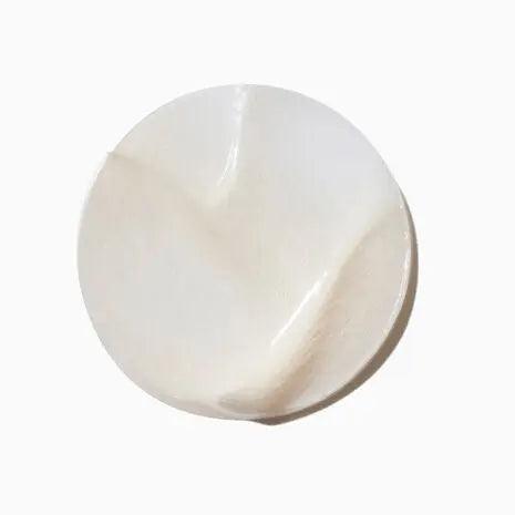 Close-up of Symbiose Masque Revitalisant Essentiel texture showcasing creamy, nourishing formula for revitalizing hair.