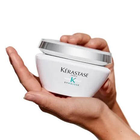 Kerastase Symbiose Masque Revitalisant Essentiel nourishing hair mask held in hands