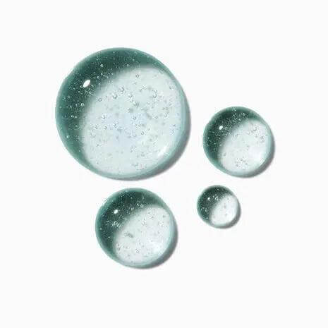 Close-up of Symbiose Sérum Nuit Intensif by Kerastase, featuring clear serum droplets against a white background.