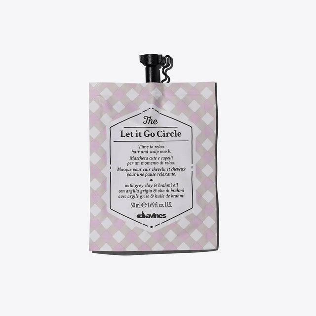 Packaging of 'The Let It Go Circle' hydrating and softening hair and scalp mask, offering a soothing wellness experience.