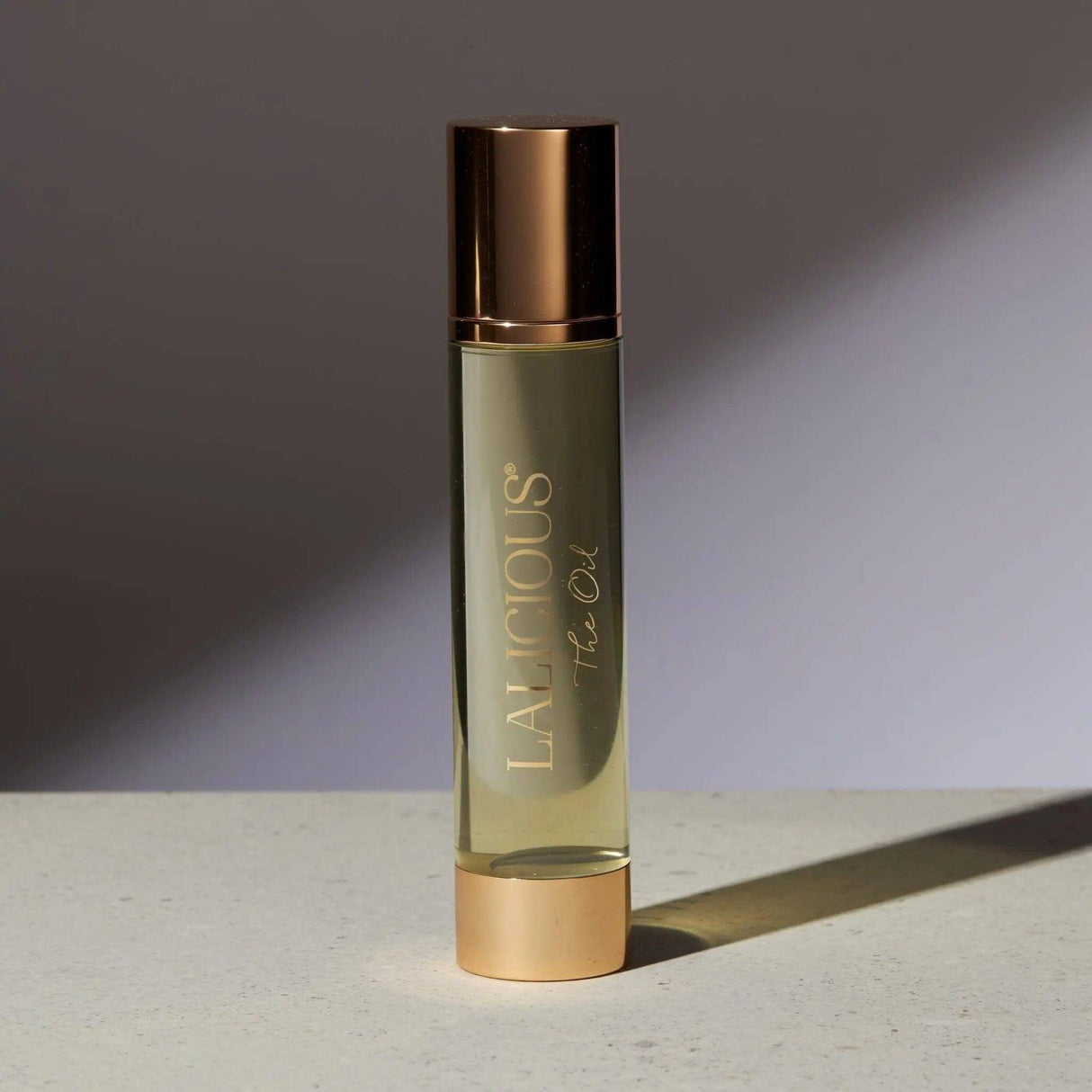 Luxury fragrance bottle of The Oil with gold accents from the Signature Collection, featuring coconut and marula oils.