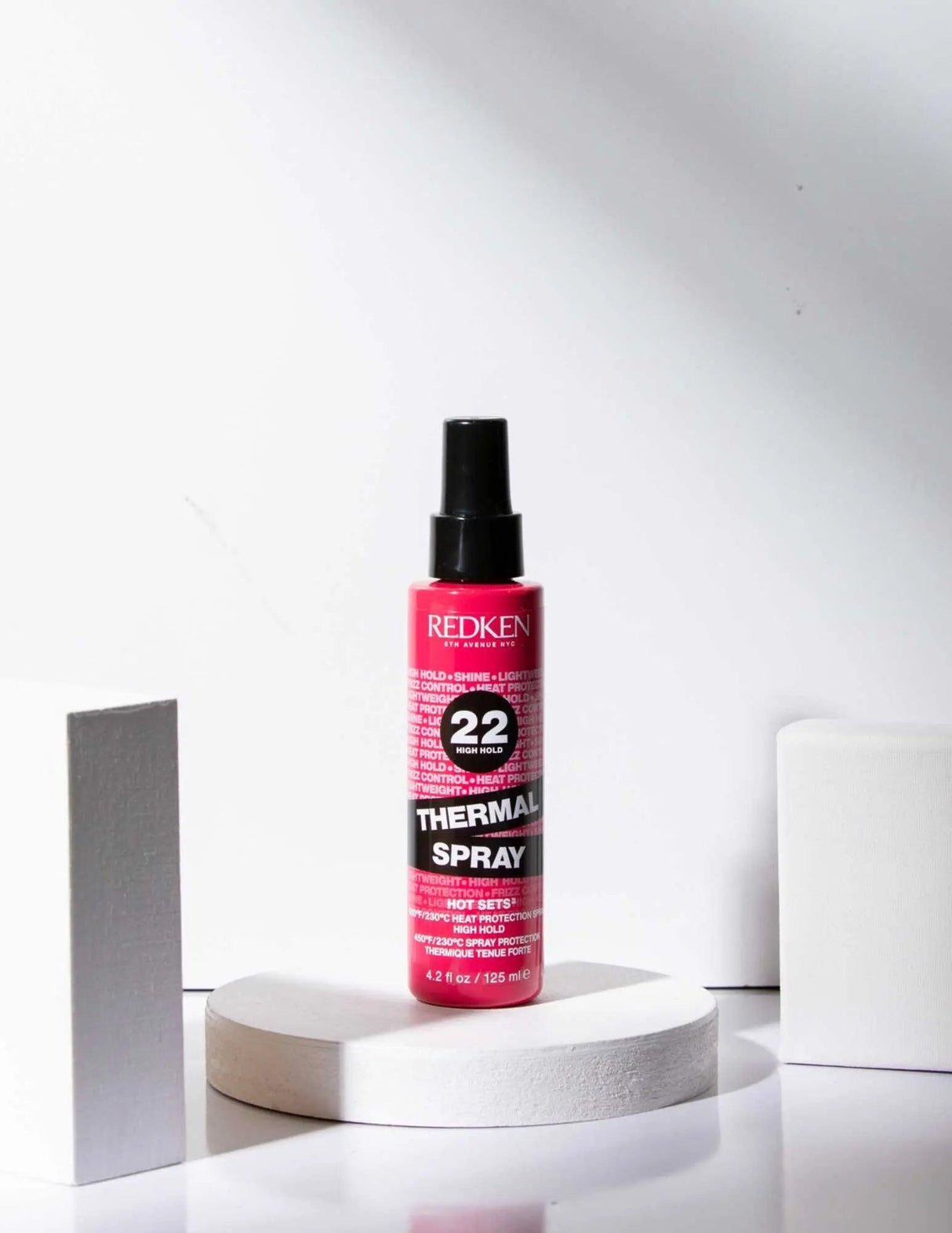 Redken Thermal Spray 22 High Hold hairspray bottle, provides heat protection and strong hold for all hair types and textures.