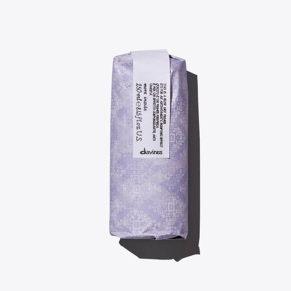 Purple wrapped packaging of Davines hair product on a white background.