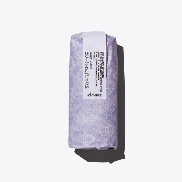 Purple wrapped packaging of Davines hair product on a white background.