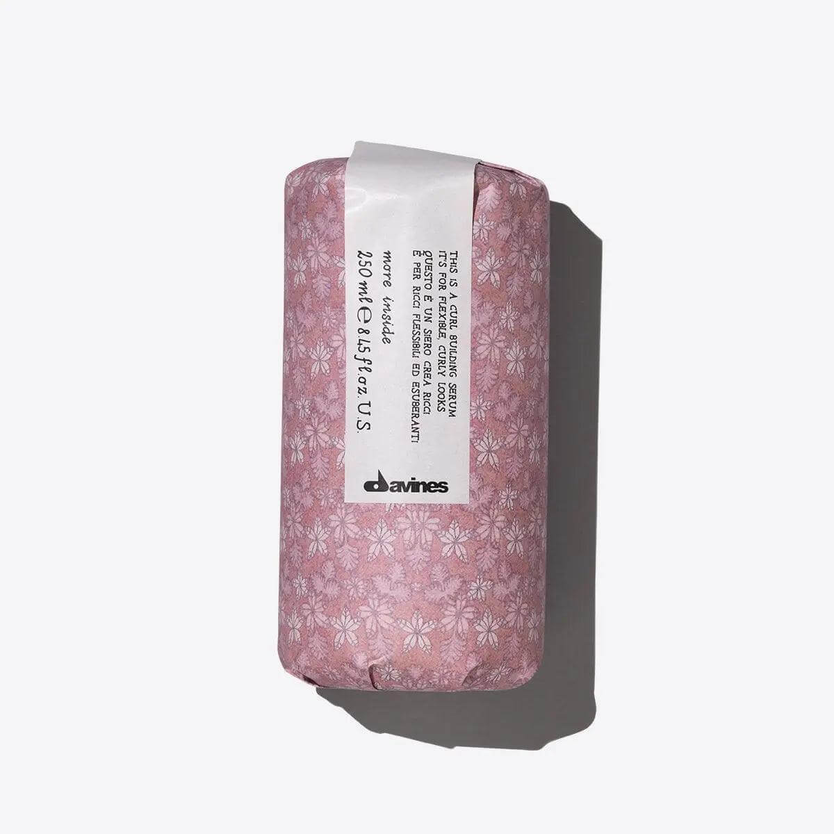 Davines hair product wrapped in pink floral paper with product label visible.