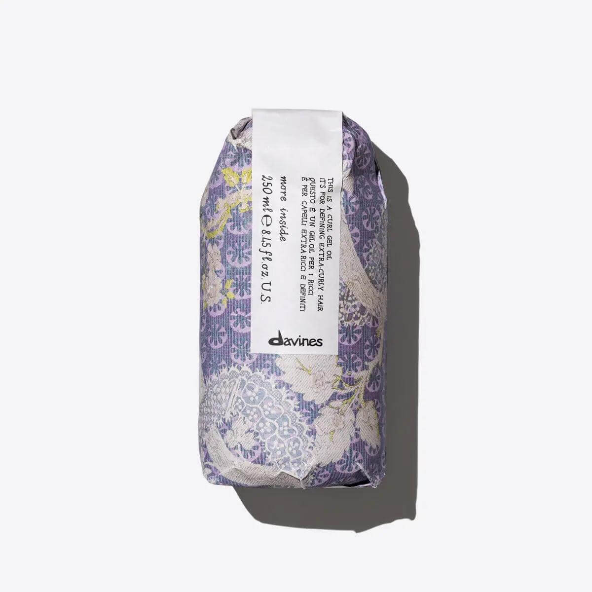 Beautifully wrapped Davines hair product in floral packaging on a light background.