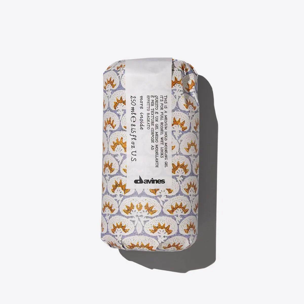 Davines product with stylish packaging, enhances curls, provides medium hold, and eliminates frizz for structured wet looks.