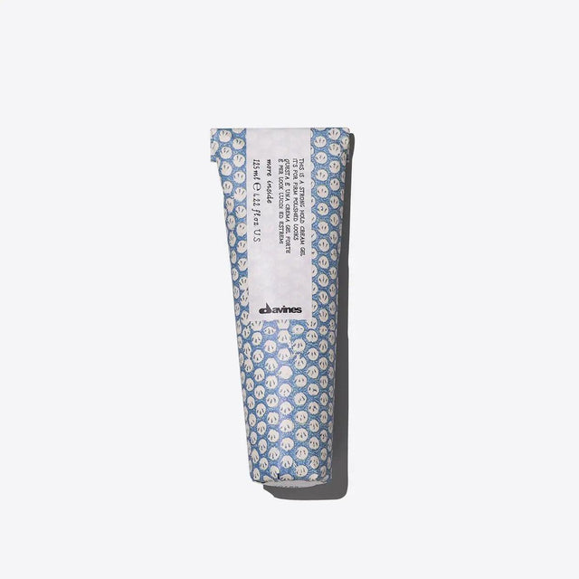 Tube of strong hold cream gel for defining short hairstyles with a wet look and frizz control, in patterned blue packaging.