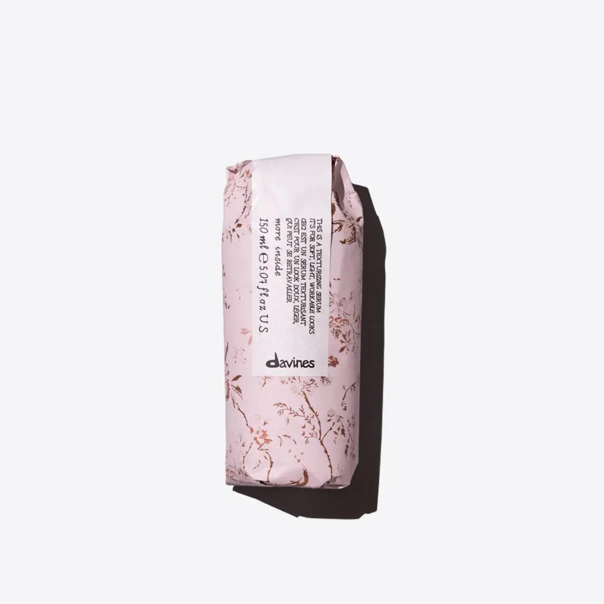 Pink wrapped texturizing hair serum ideal for adding body and shape during styling, enhancing softness and workability.