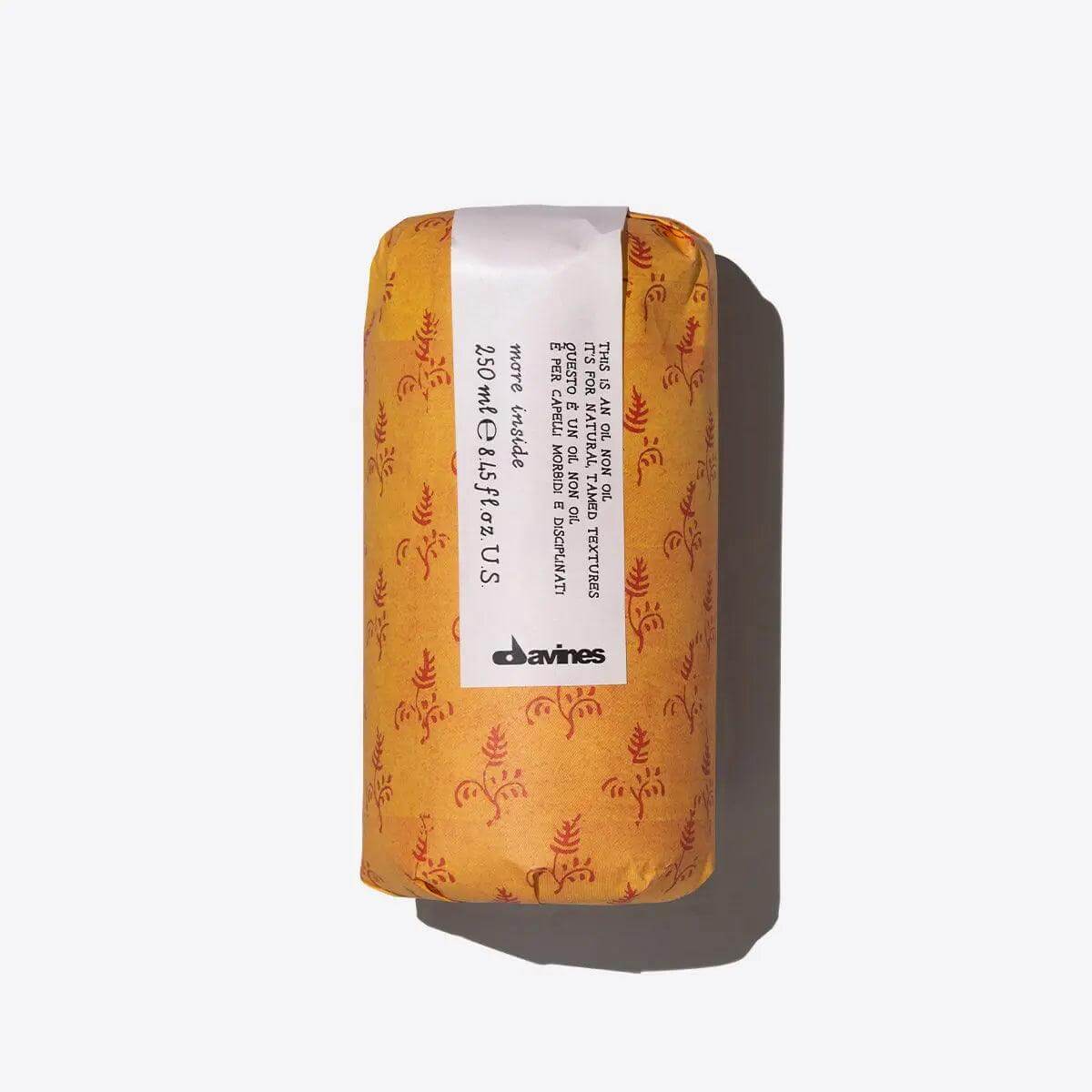Davines This Is An Oil Non Oil bottle with orange packaging, lightweight formula for hydration and frizz control.