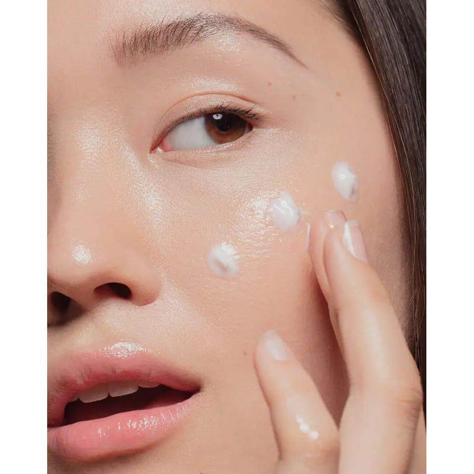 Woman applying ultra-rich moisturizer for deep hydration and skin suppleness with Retinyl Palmitate benefits