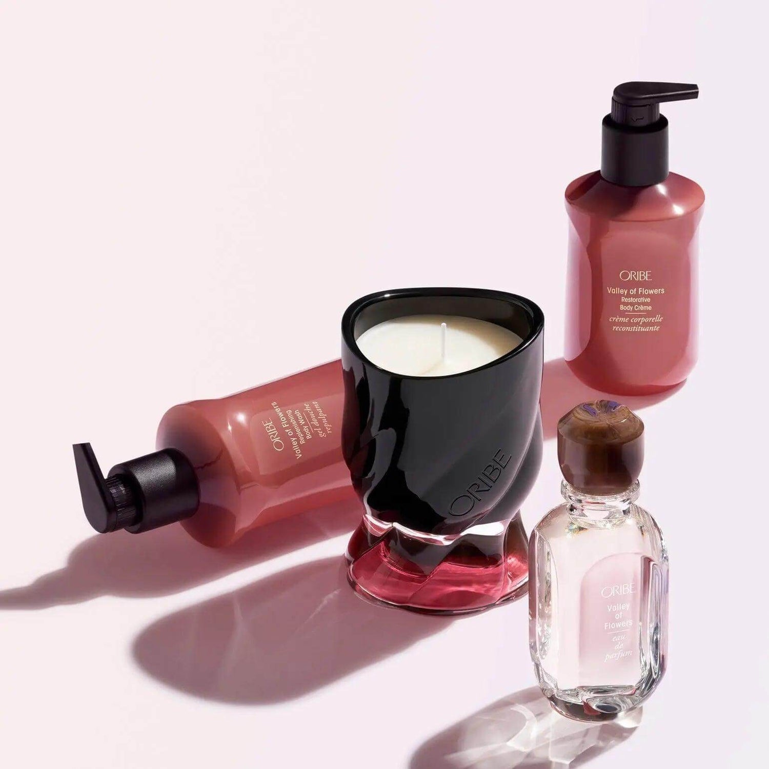 Valley of Flowers Restorative Body Crème by ORIBE with bottle and candle, 300 ml, luxurious hydration with Côte d’Azur fragrance.