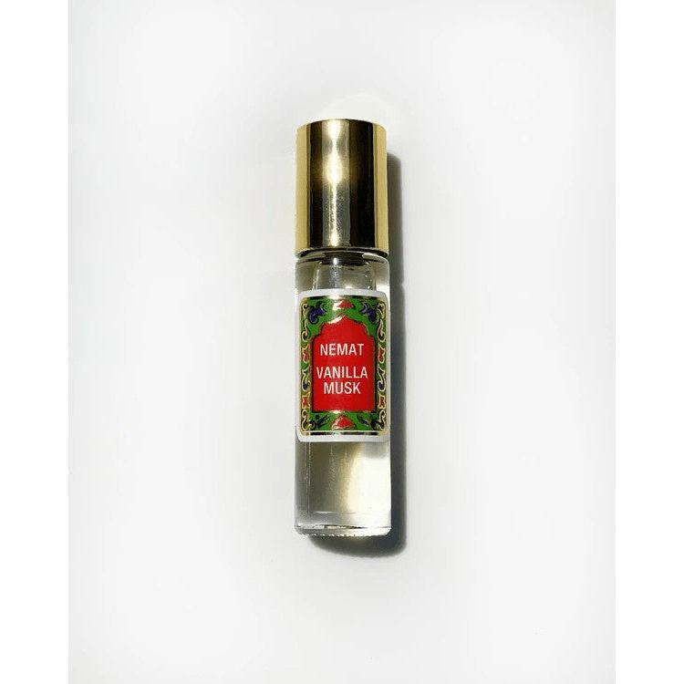 Glass bottle of Nemat Vanilla Musk roll-on perfume with a gold cap on a white background.