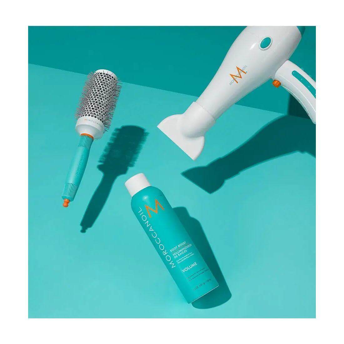 Moroccanoil Volume Root Boost with hairdryer and brush, enhances root lift for fine hair, enriched with argan oil for volume and texture.