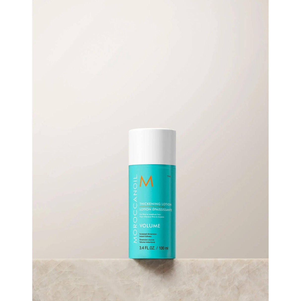 Moroccanoil Thickening Lotion bottle for volumizing fine hair with quinoa proteins and argan oil, 100ml size.