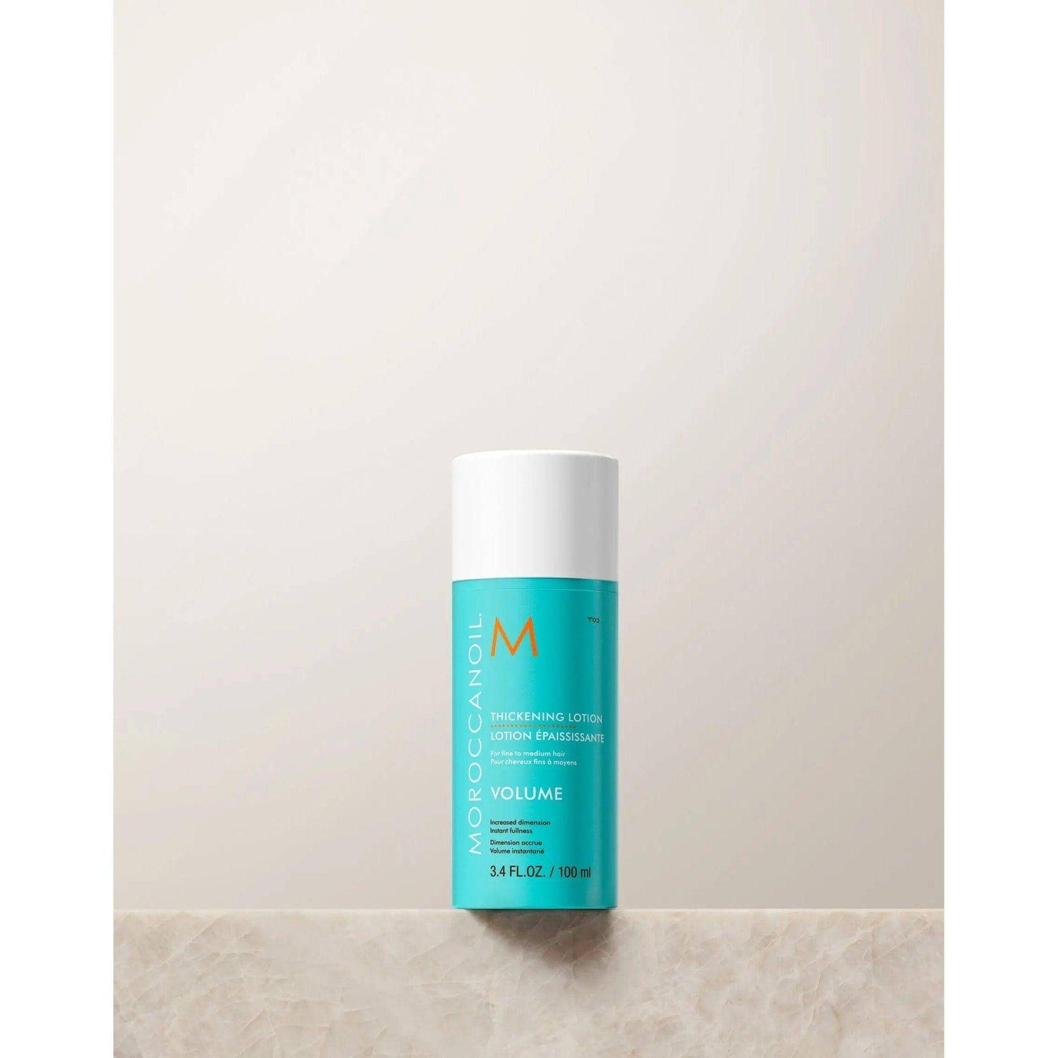 Moroccanoil Thickening Lotion bottle for volumizing fine hair with quinoa proteins and argan oil, 100ml size.