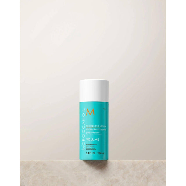 Moroccanoil Thickening Lotion bottle for volumizing fine hair with quinoa proteins and argan oil, 100ml size.