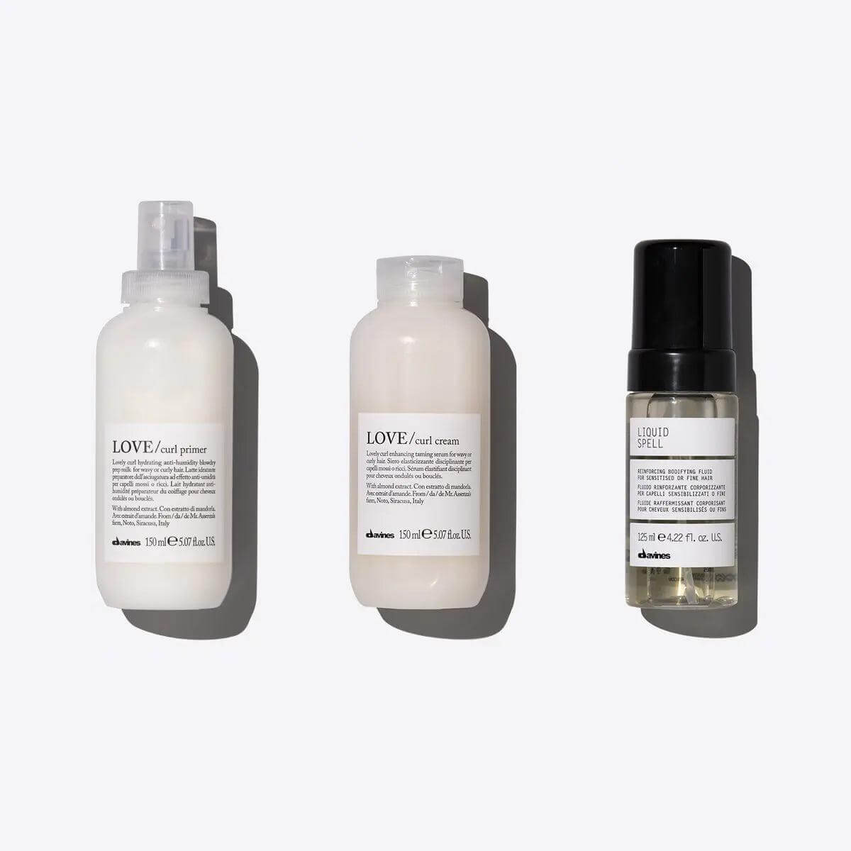 Voluminous Coils Set featuring LOVE CURL Primer, LOVE CURL Cream, and Liquid Spell for enhanced curly hair volume and moisture.