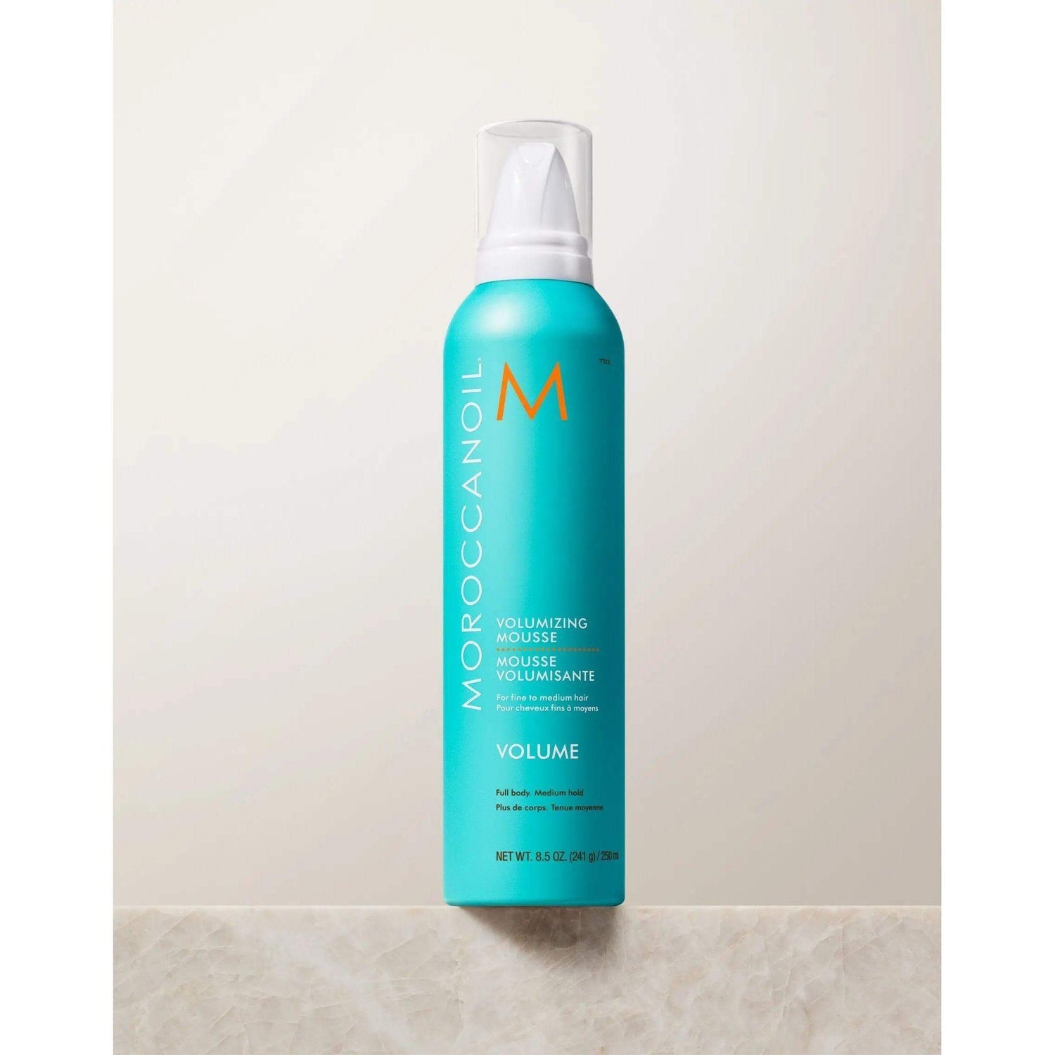 Moroccanoil Volumizing Mousse for instant volume and lift, enriched with argan oil, providing medium hold and anti-static properties.