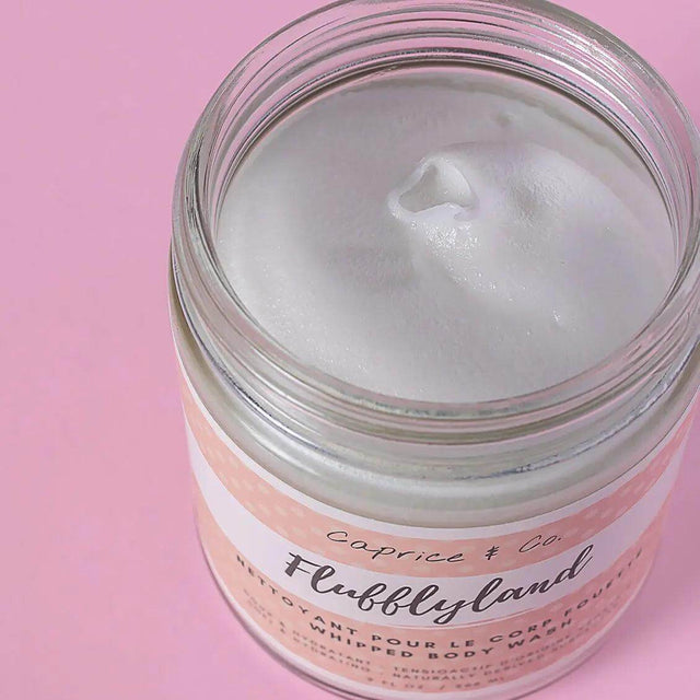 Jar of Fluffyland whipped soap, showcasing its creamy texture, set against a pink background. Ideal for vegan and sensitive skincare.