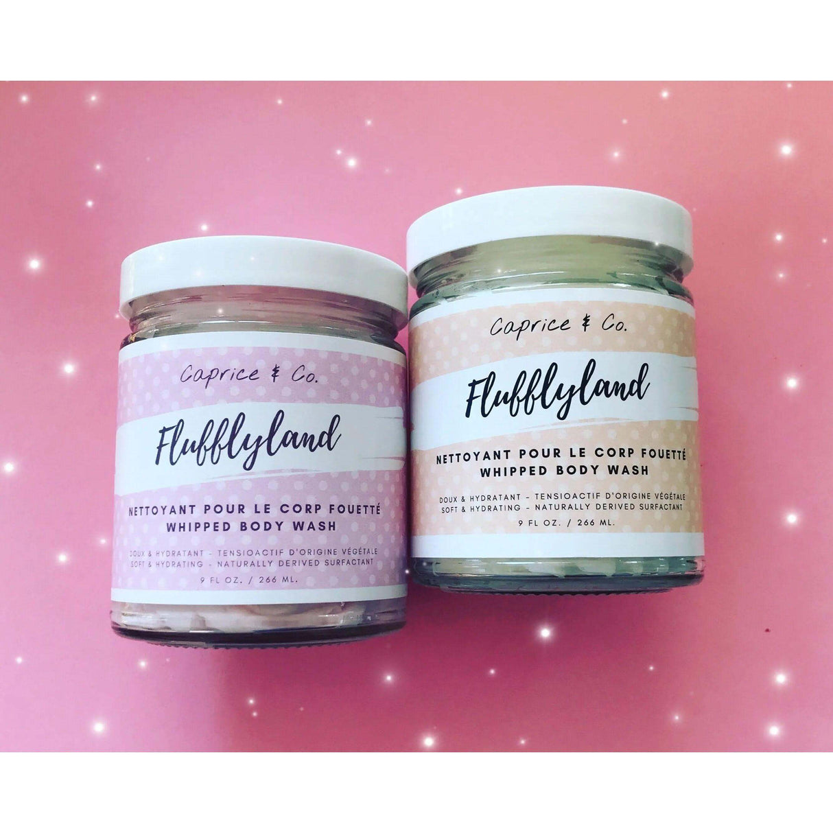 Two jars of Caprice & Co. Fluffyland whipped body wash displayed on a pink sparkling background.