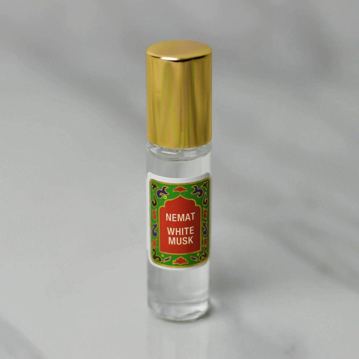 White Musk Roll-On Perfume, 10 ml bottle with gold cap, features a gentle, warm scent in premium quality applicator for on-the-go use.