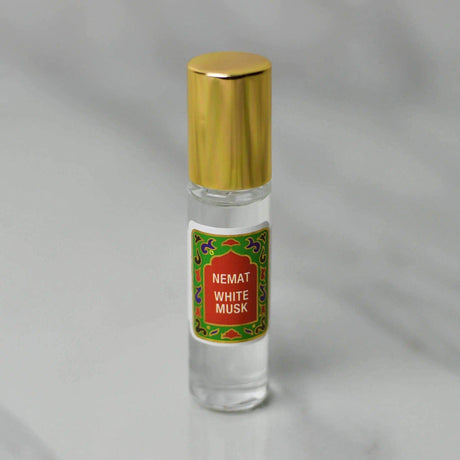 White Musk Roll-On Perfume, 10 ml bottle with gold cap, features a gentle, warm scent in premium quality applicator for on-the-go use.