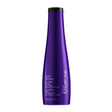 Yūbi Blonde Anti Brass Purple Shampoo by Shu Uemura in vibrant purple bottle, neutralizes yellow tones in blonde hair.