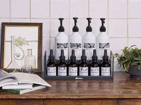 Skincare products displayed neatly on wooden countertop with decorative items.