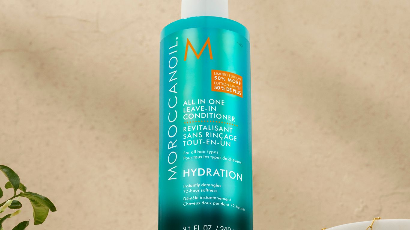 Bottle of Moroccanoil leave-in conditioner on a neutral background.