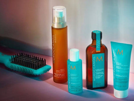 Collection of hair care products with a brush on display.