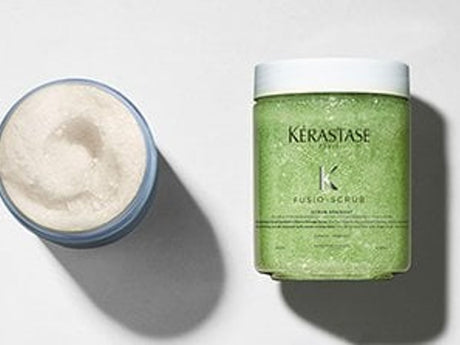 Haircare product container with open lid, cream texture visible.