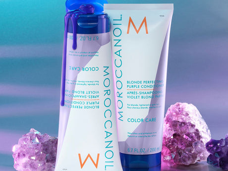 Cosmetic products displayed with vibrant crystal decorations on a colorful background.