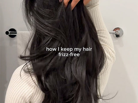 Person showing lustrous hair, text hints at frizz-free haircare tip.