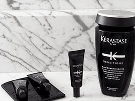 Kérastase hair care products displayed on marble surface.