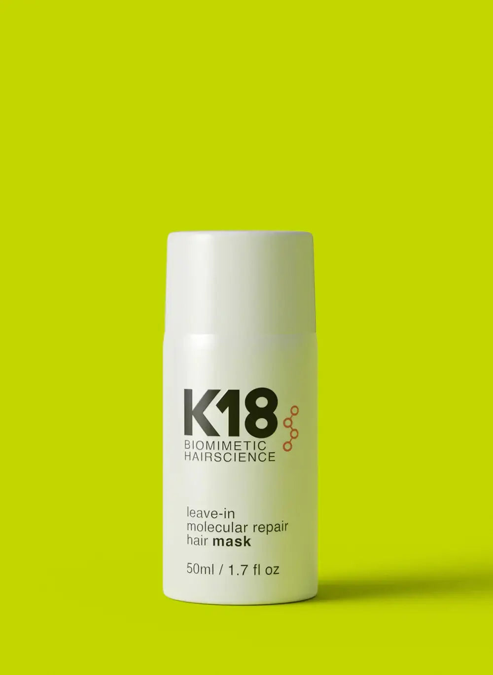 K18 Biomimetic Hairscience Molecular Repair Leave-in Mask on a green background